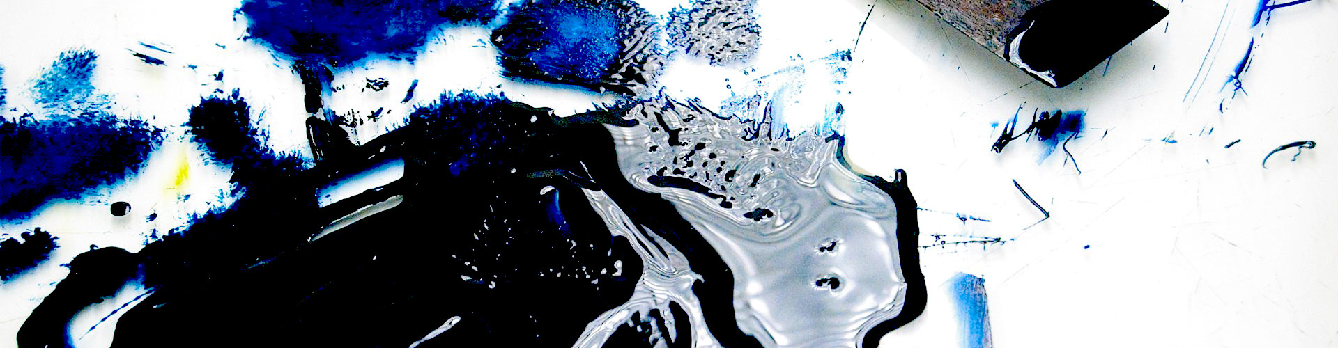 A blue and silver paint-like spill with a paint spatula